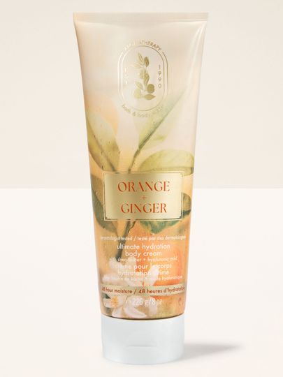 Krem do ciała Bath & Body Works Aromatherapy Orange + Ginger 226 g w jasnej tubie z roślinnym motywem.