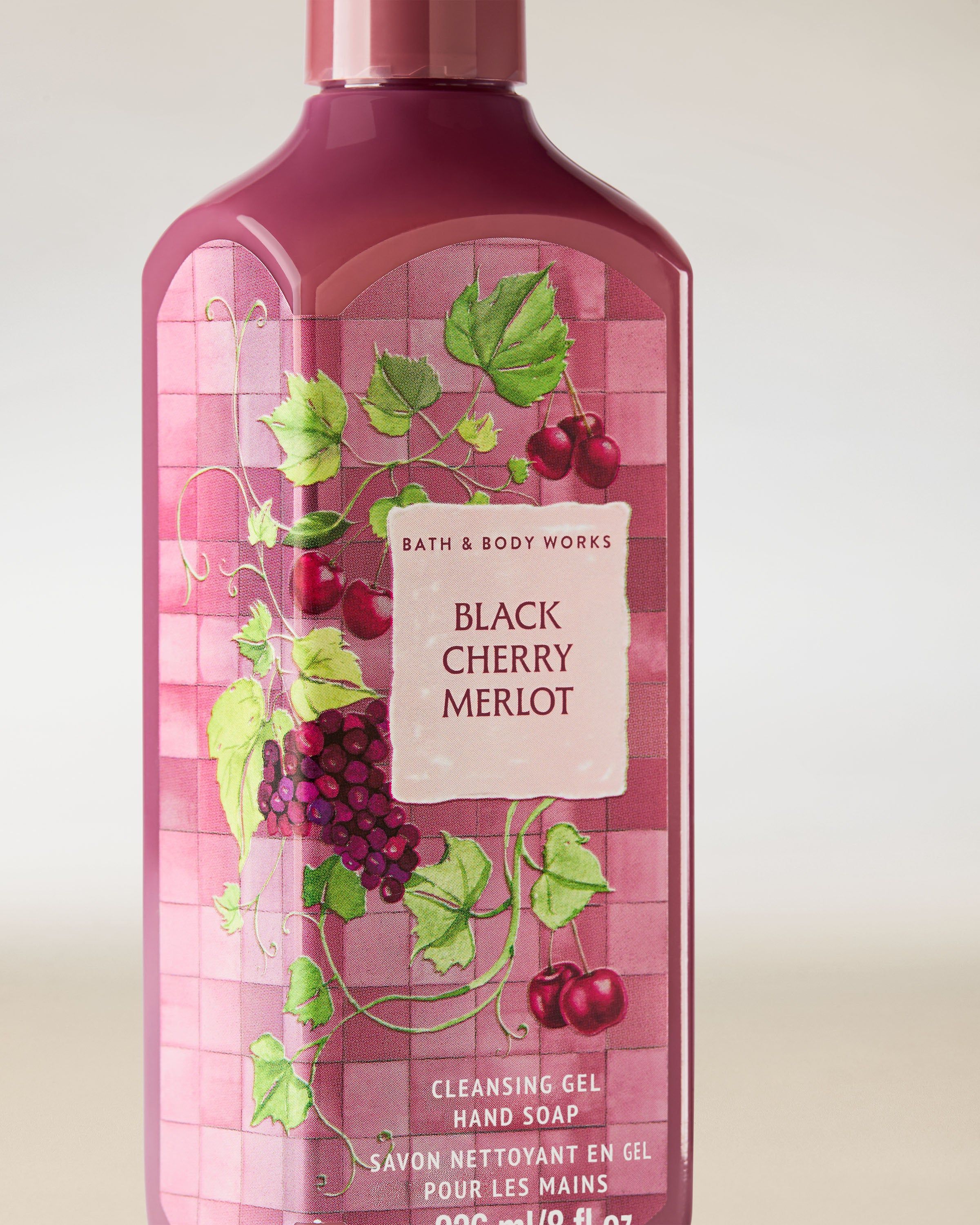 Żel do mycia rąk Bath & Body Works Black Cherry Merlot 236 ml w różowo‑bordowej butelce z motywem wiśni.