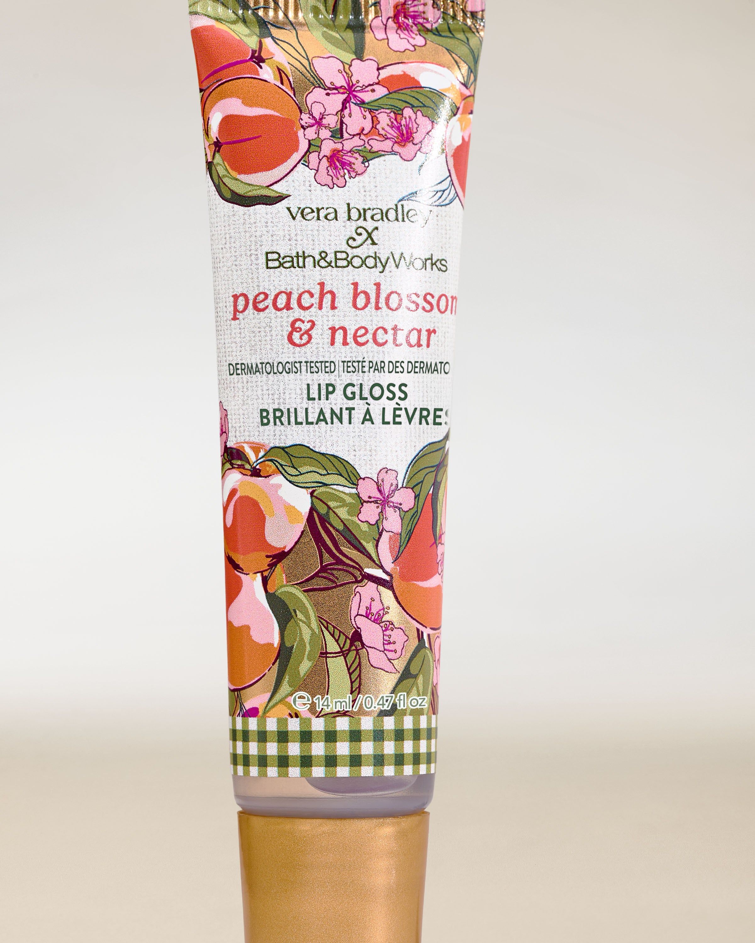 Bath & Body Works Peach Blossom & Nectar – błyszczyk do ust w tubce z brzoskwiniowo‑kwiatowym wzorem.