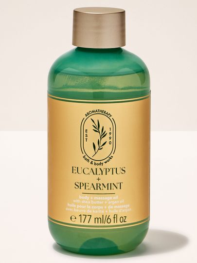 Olejek do masażu Bath & Body Works "Eucalyptus + Spearmint" z masłem shea i olejem arganowym, w zielonej butelce.