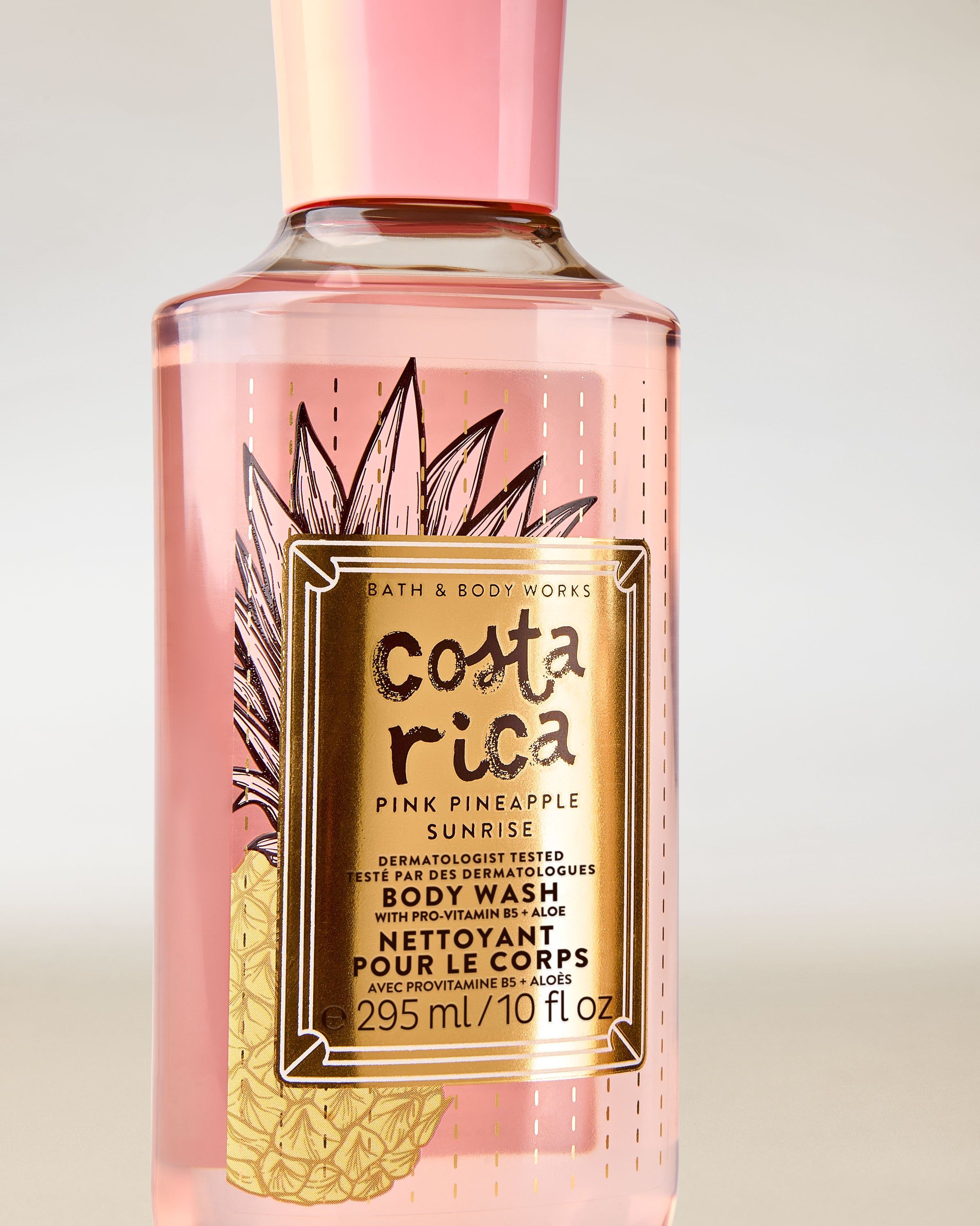 Żel pod prysznic Costa Rica Pink Pineapple Sunrise w różowej butelce z tropikalną etykietą i różowym korkiem.
