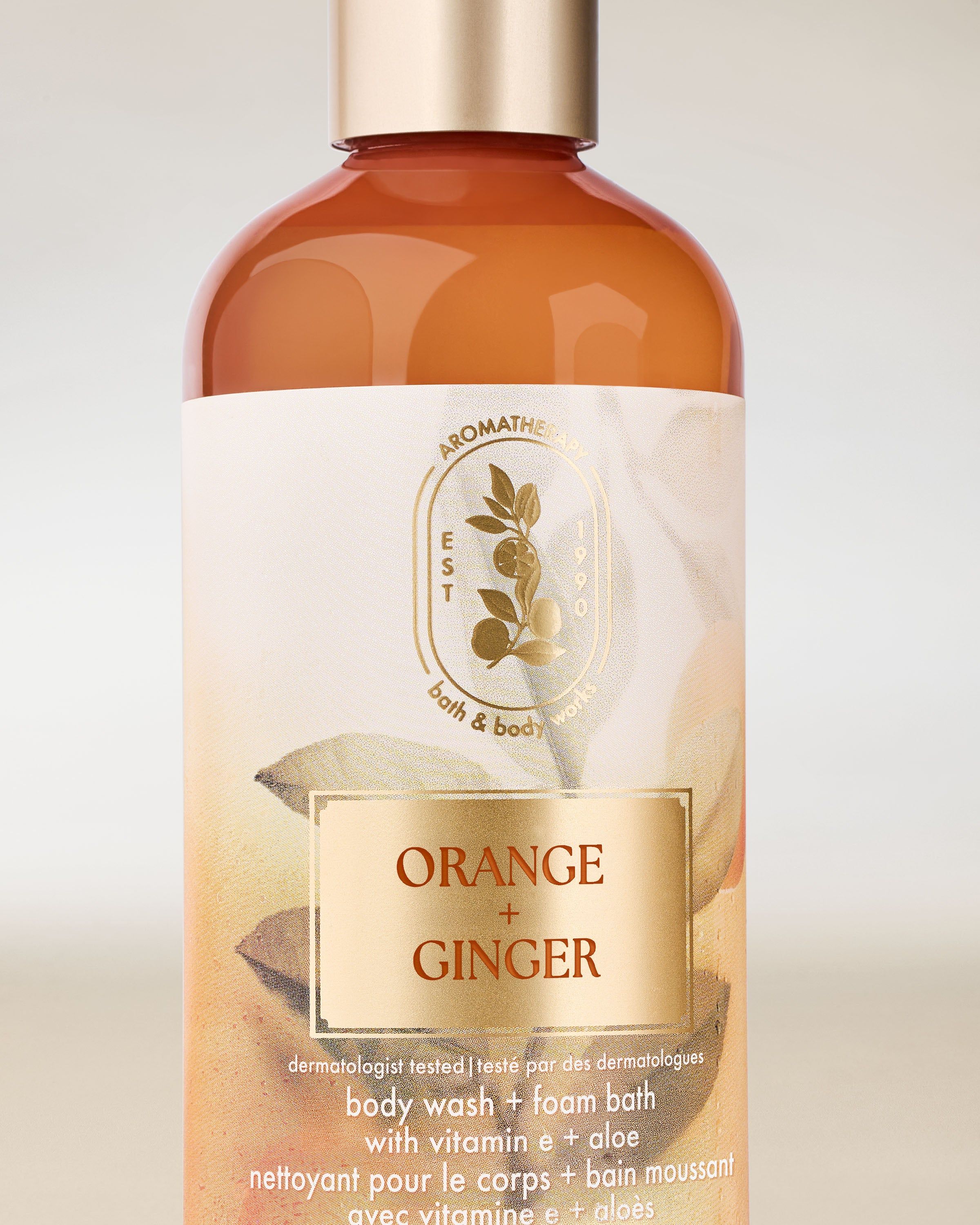 Żel pod prysznic Bath & Body Works Aromatherapy Orange + Ginger 295 ml w pomarańczowej butelce z zakrętką.