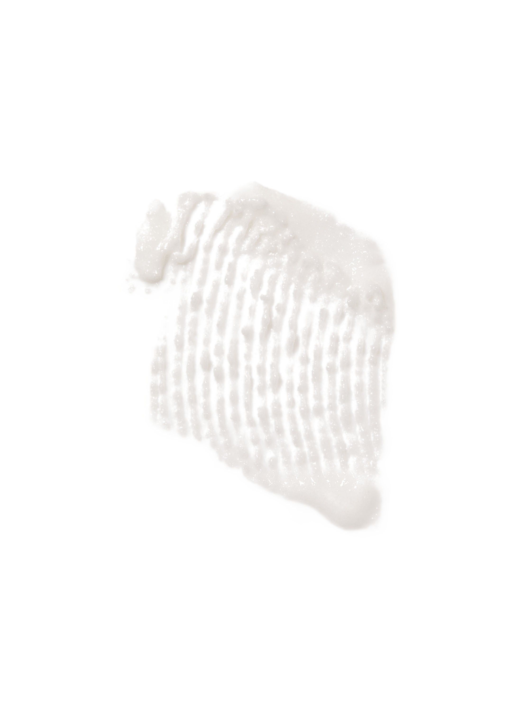 Swatch peelingu (pilingu) cukrowego rozsmarowany na białym tle. Widoczne granulki i kremowa tekstura.