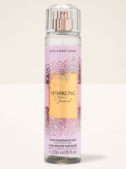 Mgiełka do ciała Sparkling Toast Bath & Body Works w różowej butelce ze złotą, błyszczącą etykietą