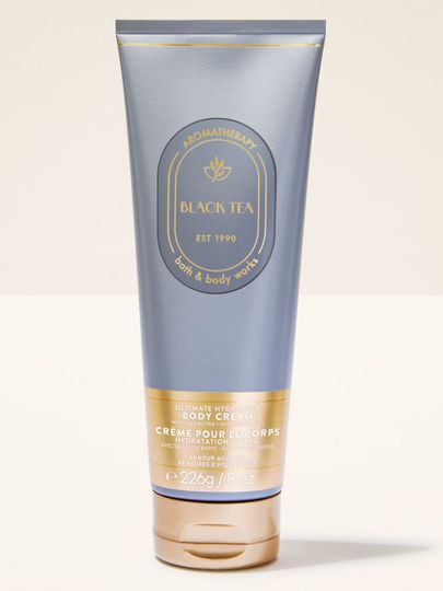 Krem do ciała Bath & Body Works Aromatherapy "Black Tea" w szarej tubce ze złotymi akcentami i zakrętką.