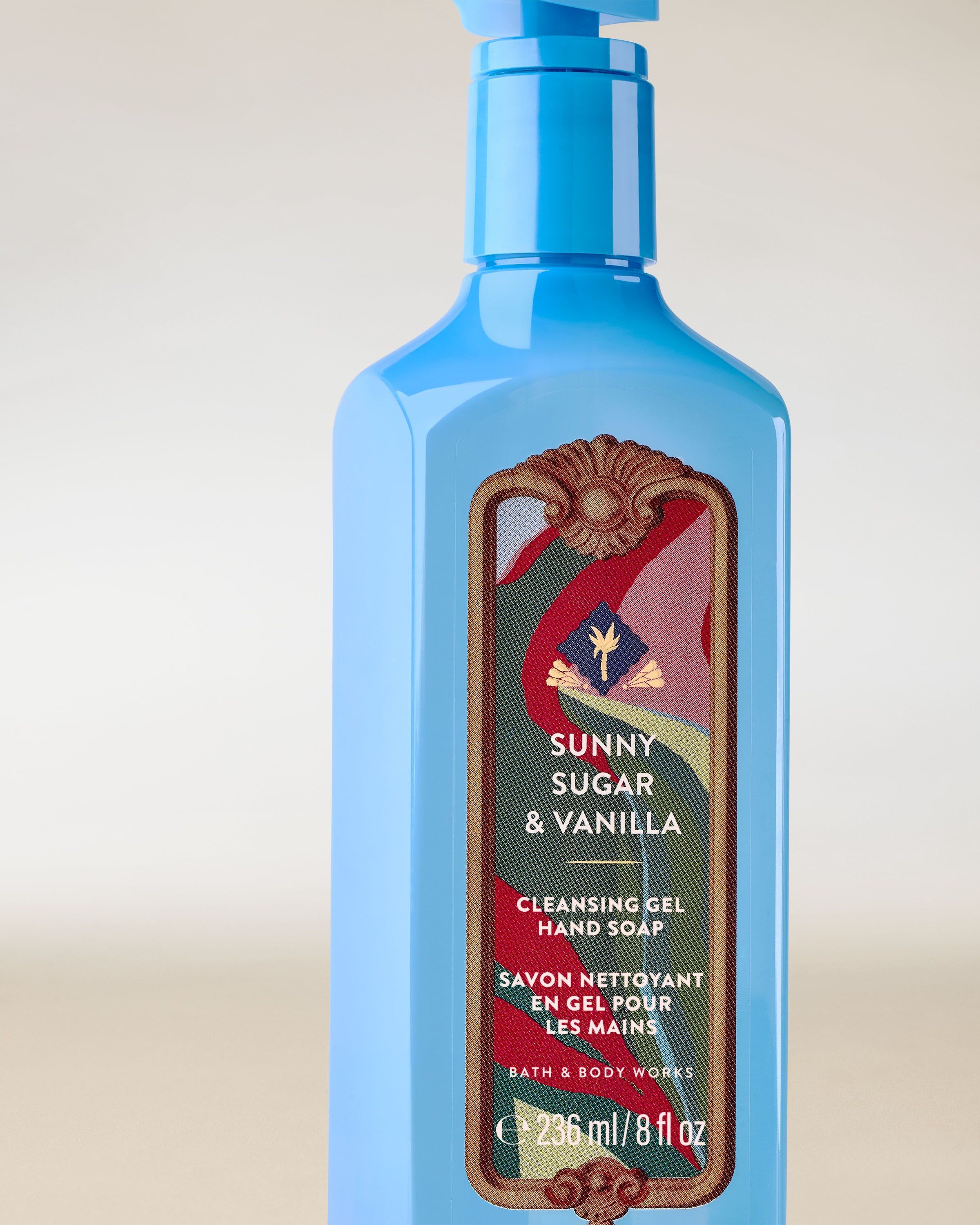 Sunny Sugar & Vanilla – niebieski żel do mycia rąk z pompką i dekoracyjną etykietą w ciepłych, słodkich odcieniach.