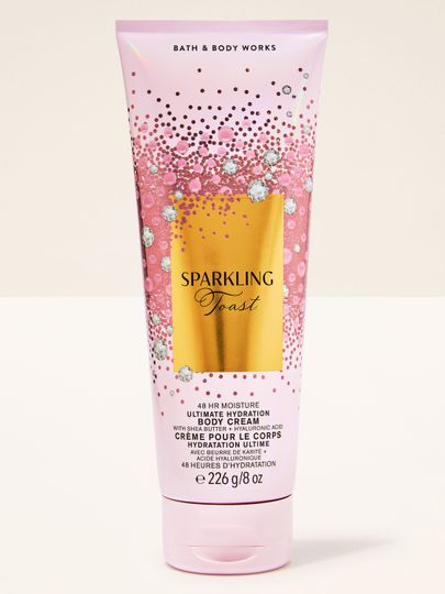 Krem do ciała Sparkling Toast Bath & Body Works w różowej tubie ze złotą, błyszczącą etykietą