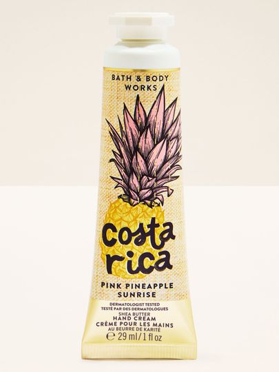 Krem do rąk Costa Rica Pink Pineapple Sunrise w żółtej tubie z ilustracją ananasa i tropikalnym motywem.